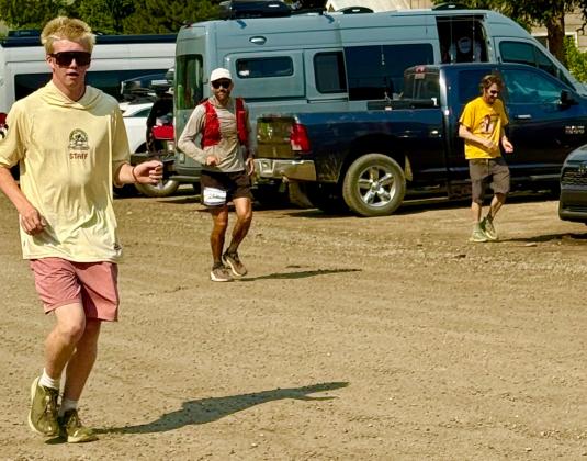 Silverton locals Phen and Steve Mead run with their longtime friend Ben Wyrick as he completes the Hardrock 100 photo by Missy Izard