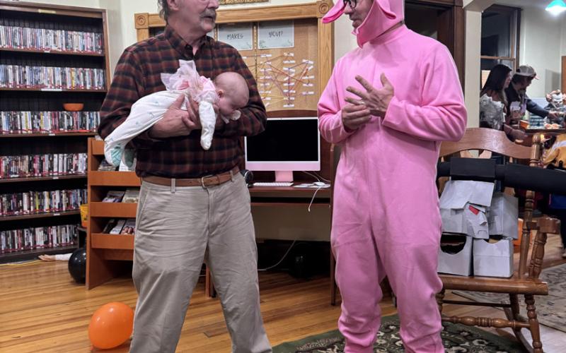 Photo credit Katey Fetchenhier Off-duty San Juan County commissioners Scott Fetchenhier and Austin Lashley (with baby Rudie Fetchenhier-McChesney) at the library Halloween Party.