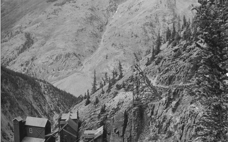 The Old Hundred Mine in 1906, from above and southeast of the improvements. Shows all improvements in place at the height of operations, including boarding house, tram buildings and portal and entry structures. View is from higher on Galena Mountain in a northwesterly direction, toward Brendel Gulch on Macomber Peak San Juan County Historical Society photo