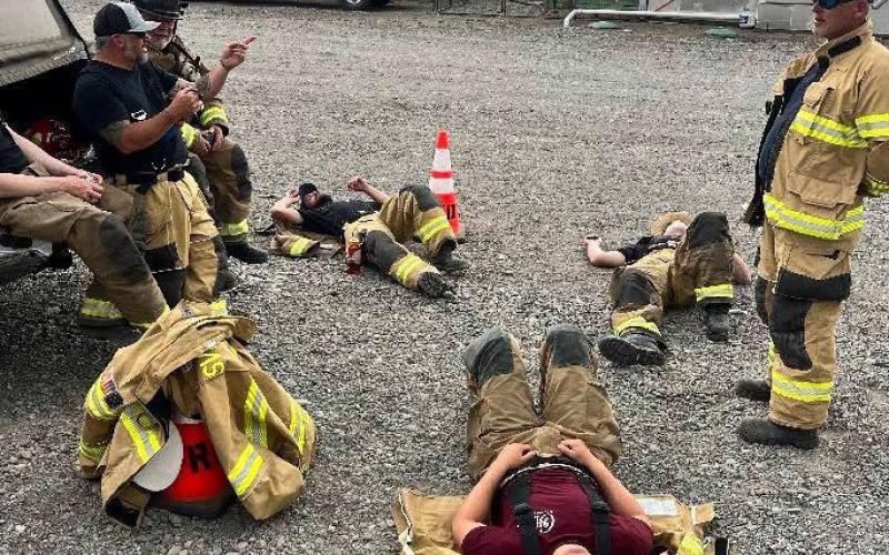 The volunteer Silverton fire team take a break after a grueling morning of training. Photo credit SSJCVFD
