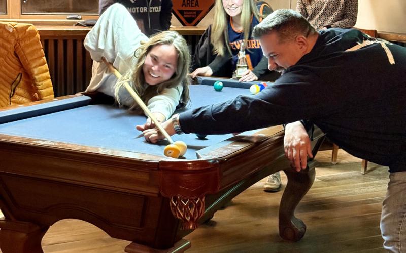Building bridges, Jim Harper helps Lucy Mulvihill make her shot photo by DeAnne Gallegos