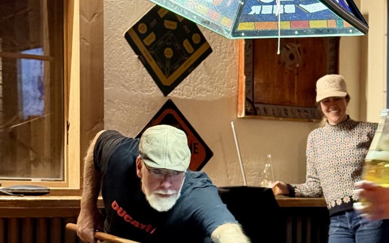 Longtime local Bruce Conrad enjoys an evening out with friends playing pool at the Eureka Station, as Sarah Moore cheers him on photo by DeAnne Gallegos