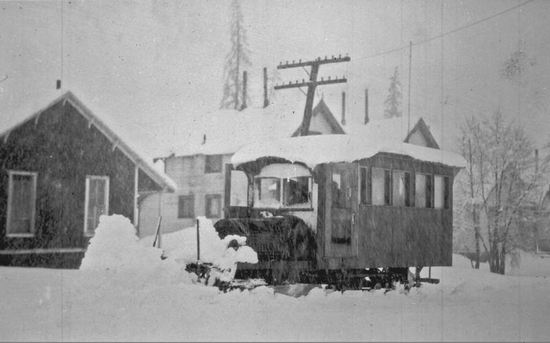 One of the George Boss stages in 1200 block of Greene Street, circa 1910. The photo shows an open buggy with at least 10 persons on it, pulled by four-horse team, facing northeast on Greene Street. The man on white horse at rear of stage is talking with someone on stage. San Juan County Historical Society photo