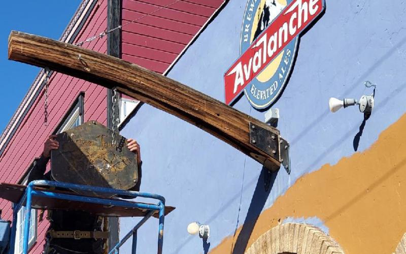 The New Alpine Tavern sign was installed this week, and the changing of the guards has begun. Photo credit Jim Harper