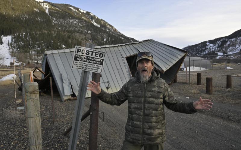 Fred the Weather Man in front of the San Miguel Power coop shed that got tumbled for more than 200 feet early Sunday morning