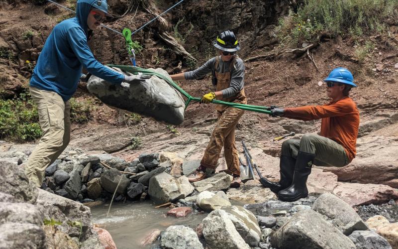 The professional trail builders do have to zip line boulders and other trail building materials as part of the job. Photo credit Michael Crockett