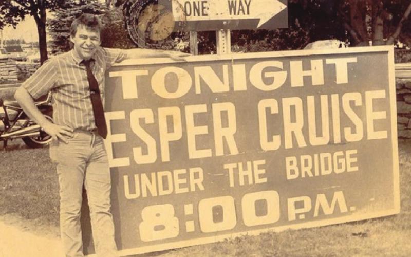 Mark in his twenties; he stood in front of the “v” in the sign. Photo Credit Margaret Westerman