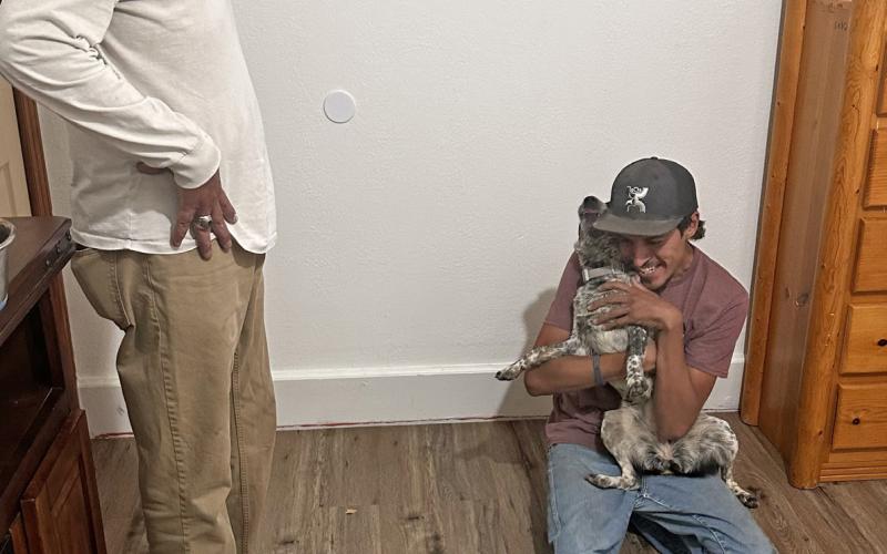 The Rodriguez Family reunites with their missing dog Luna after 14 days, Tanner Rodriguez holds her tight. Photo credit Jimmy Keene