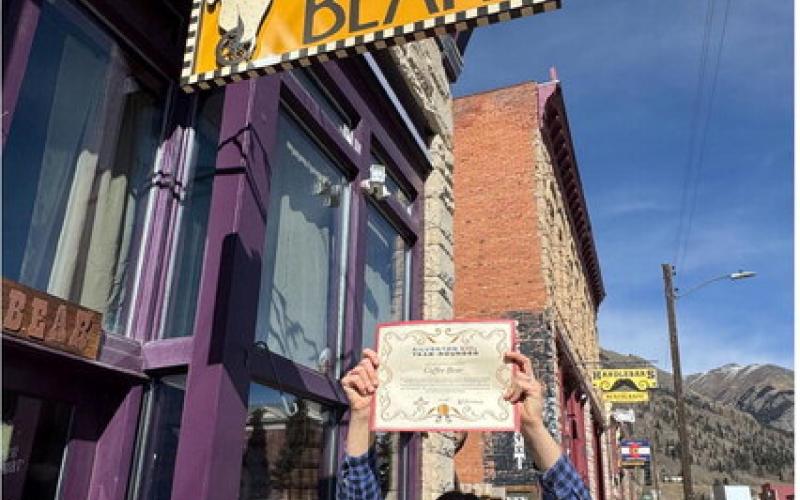 Coffee Bear owner Holly Huebner shows off her YearRounder certificate given to her by SJDA Director Sarah Moore. Photo by SJDA