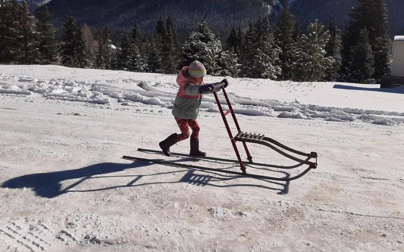 Photo credit Larry Raab Four year old Claudia kick sledding on Snowden Street.