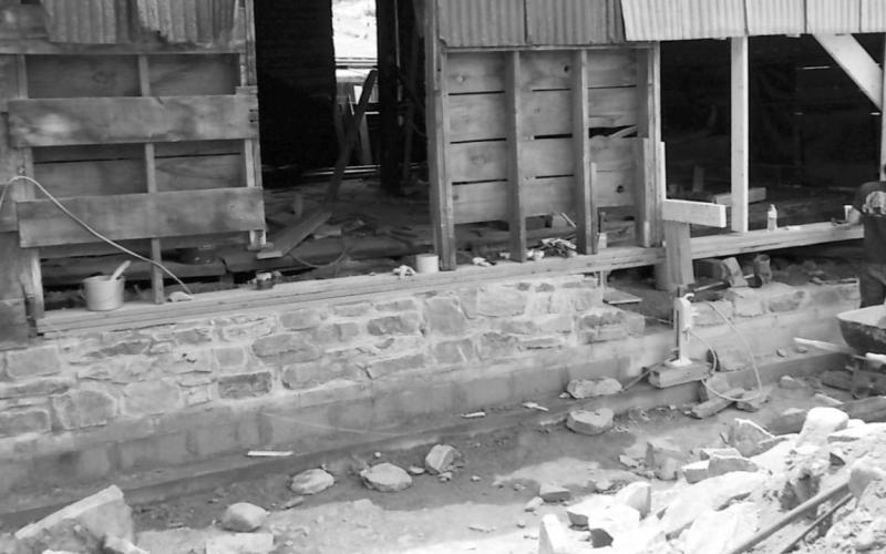 Many areas of the foundation required extensive work by Scott Craig and his crew, seen here working on the back room.