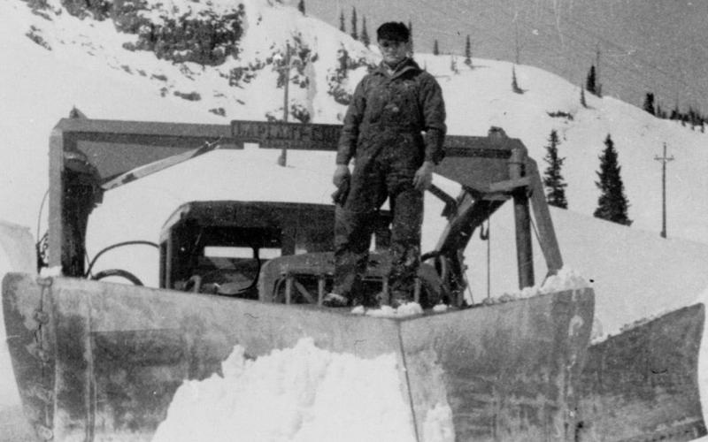 Red Mountain Pass, 1932 A 21-foot A-shaped wedge plow on U.S. 550 on Red Mountain Pass, with Louie Dalla standing on the blade.