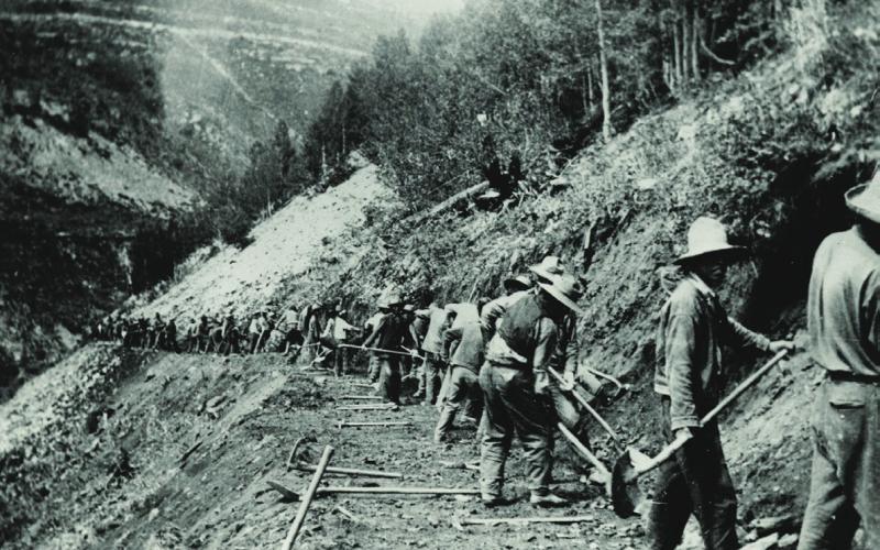 After the new Colorado Highway Department was asked to take over the former Otto Mears toll road from Ouray to Silverton in 1916, portions of the route were rebuilt to locations much higher above the Uncompahgre River to avoid frequent flooding. In 1918, this was how a new portion of the road high above the river was being constructed. It was tough, painstaking work by hand and with explosives. Colorado Department of Transportation Archives, Denver.