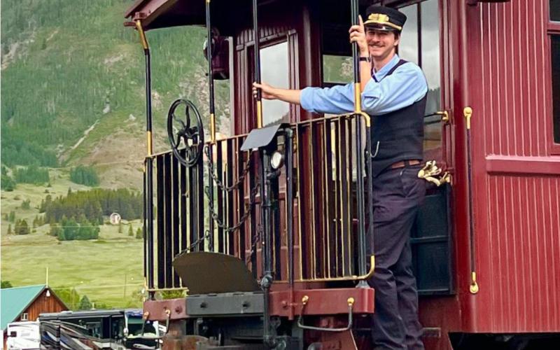 DSNGRR employees are always all smiles &amp; happy. Nick Battelo moved to Durango just to work for the Durango Silverton Narrow Gauge Train &amp; loves being a Brakeman. Photo Credit - Silverton Area Chamber of Commerce