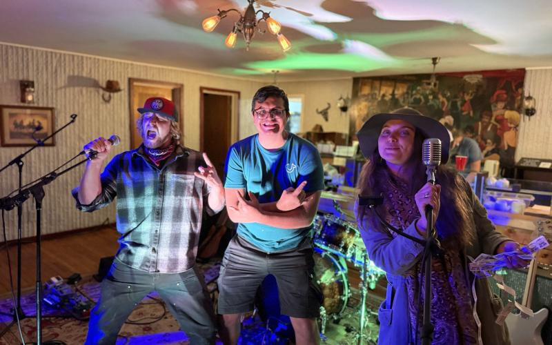photo by DeAnne Gallegos During the fundraiser, life long friends Levi Loki &amp; Gerardo Acosta Jr and Elizabeth Rowe all take the stage while the bands were on break.