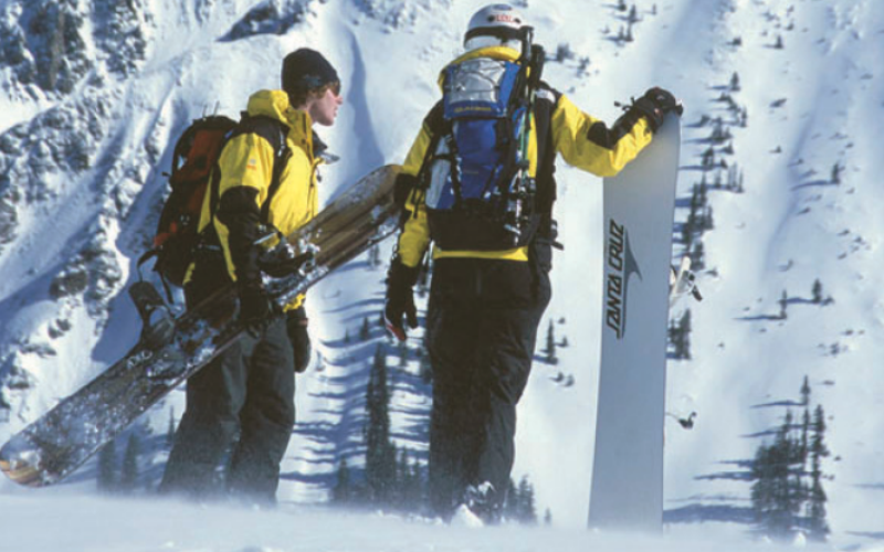 Jen and Aaron Brill 2002 Silverton Mountain. Aaron holding his calling card- a super large snowboard. (photo Scott DW Smith)
