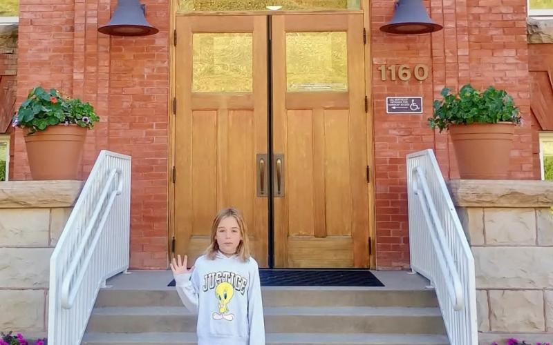 photo by Megan Brosh Maxine Brosh is starting 5th grade, waving to her mom, Megan Brosh.
