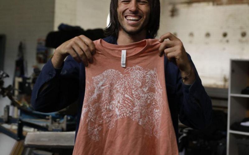 Julian Marcos Hood with one of his t-shirt prints from his business Thees Tees. Photo By Julian Marcos Hood