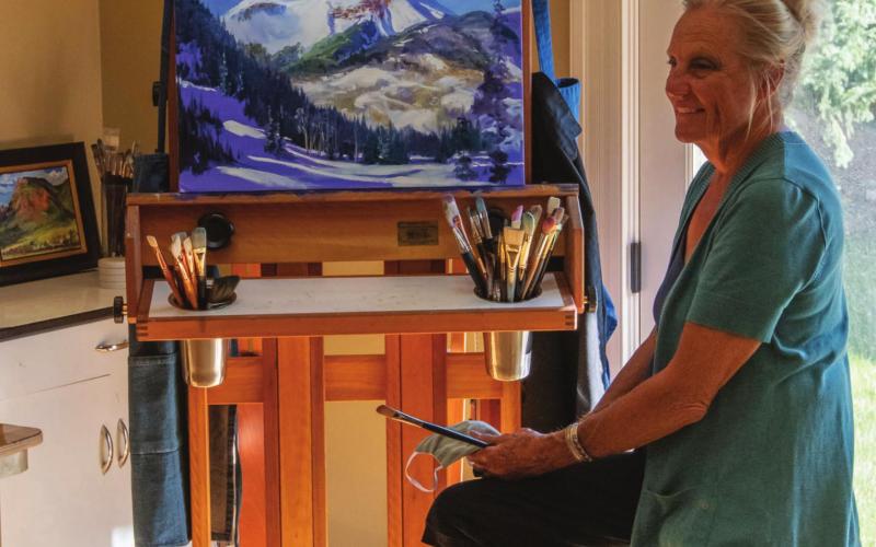 Eileen Fjerstad in her studio with a painting of Engineer Mountain in progress. Photo Credit Wesley Berg