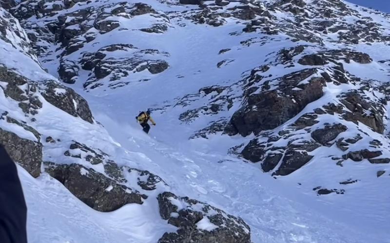 Silverton Mountain Guide Calvin Davenport drops in the chute photo by Silverton Mountain