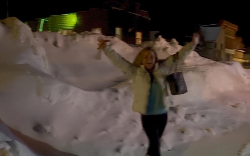 Lisa Risoli shows off the pile of snow that was building on Blair Street from the snowstorm photo by DeAnne Gallegos