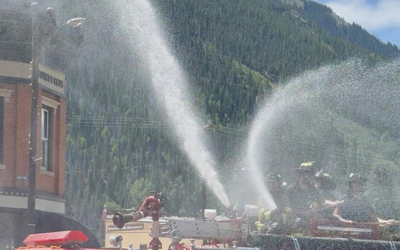 (RIGHT) photo by DeAnne Gallegos Silverton Fire Department spraying water over parade on the 4th of July