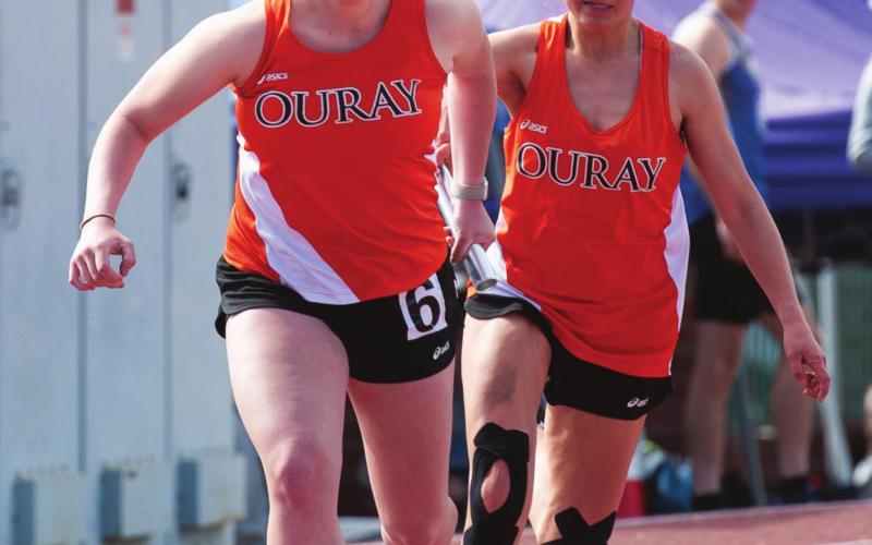 Belen Roof grabbing the baton from her teammate from Ridgway in the 4x100 relay. Photo Credit David Emory
