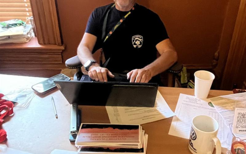 Silverton Medical Rescue’s Michael Burton checks symposium attendies in at Town Hall. photo by Nancy Stanley