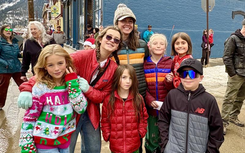 photo by Anne Izard Kim Meded poses with a group of Silverton Kids waiting to sit with Santa