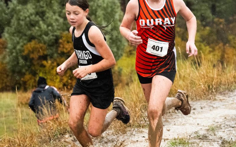 Silverton’s Kate Barney runs on a rainy day during last weekend’s cross country race in Chicken Creek Photo by Dave Emory