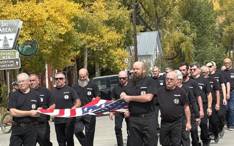 All members of the SSJVFD march behind the antique fire truck to the St Patricks Catholic Church last Saturday. photo by Barbara McLachlan