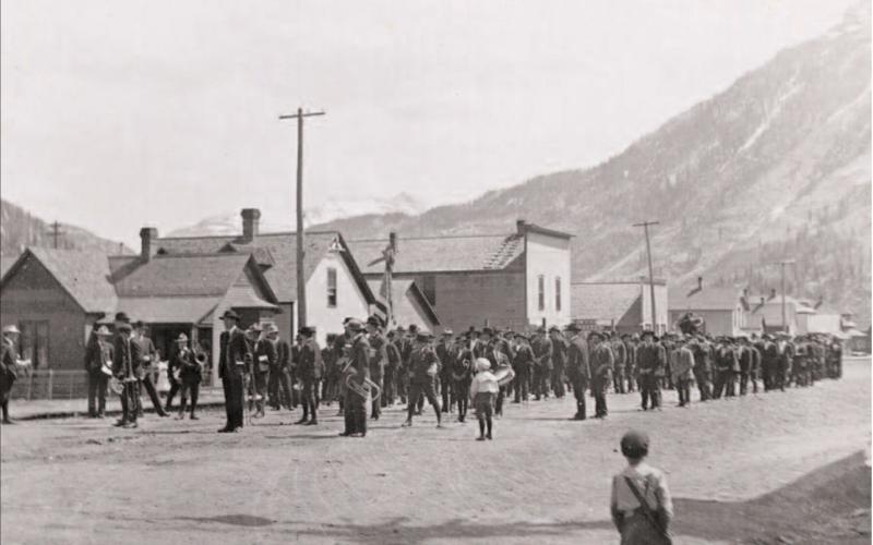 In the top photo, union men form on the 1000 block of Greene Street to march to the cemetery in June 1908 following the deaths of six miners in a fire at the Gold King Mine at Gladstone. A boys band lined up in front of the miners’ group. In the background can be seen the old Alamo Hotel and Curry’s store building. Photos courtesy of San Juan County Historical Society