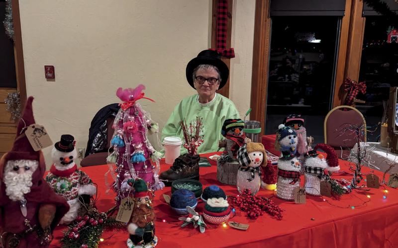 Photo credit Silverton Creative District Deborah Runion looking festive at her table for the Mistletoe Market.