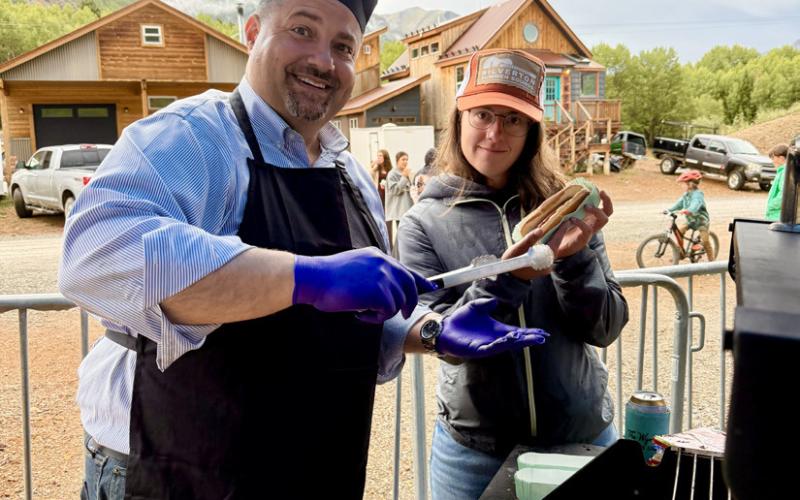 Silverton Mayor Jim Harper grilling hot dogs and Town of Silverton Trustee Lindsey Halvorson was his sous chef photo by DeAnne Gallegos