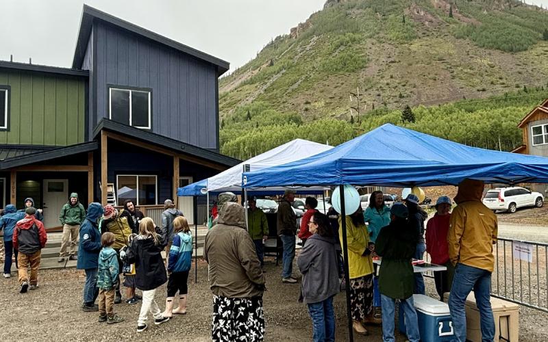 Crowd of locals under the tents trying to stay out of the rain during the open house event photo by DeAnne Gallegos