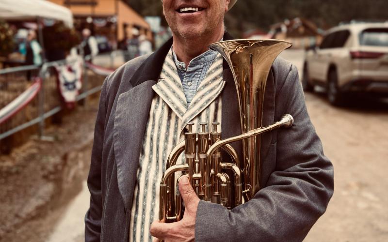 Willy Tookey, a longtime member of the Silverton Brass Band. The band played under the cover at the High Noon to avoid the monsoon rain. Dozens of spectators crowded the benches to hear the band play. photo by Amber Tookey