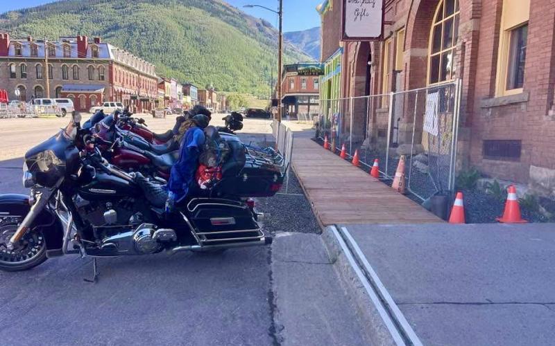 Brian Anderson of 9138 Construction put in a temporary wooden sidewalk in front of the Ol’ Livery as part of a revitalization project on Greene St to help the fellow businesses with direct access for tourist photo by Ken Webb
