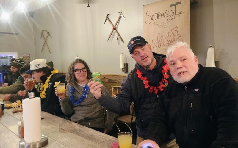 Beth and Brian Anderson hang out with Bevan Harris at the Dera Deli on Cocktail Crawl night for Snowscape photo by Megan Brosh