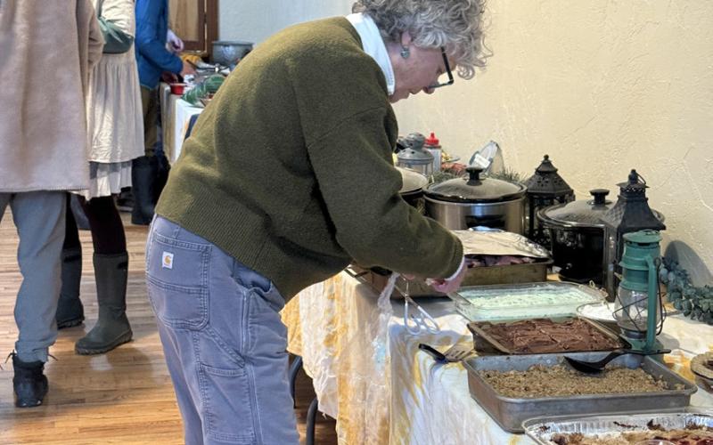 Karla Safranski brings a dessert to community feast photo by DeAnne Gallegos