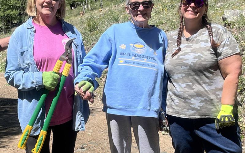 Community volunteers helped tidy the hillside grounds on Cemetery Cleanup Day photo by Scott Fetchenhier