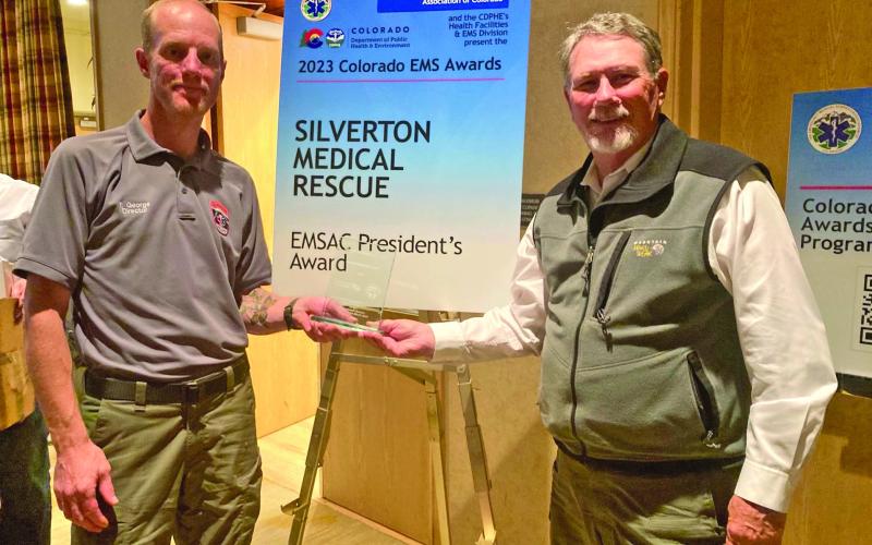 Tyler George, current director of Silverton Medical Rescue (left), and Kimmett Holland (right), former Silverton Ambulance Association director, receive President’s Award at the EMSAC state conference on Nov 4th. Photo credit Kathy Wright