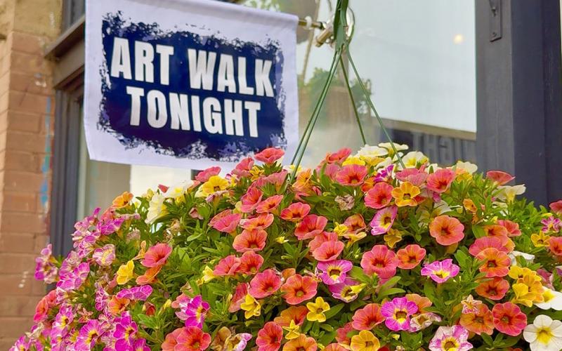 Beautiful flower basket and new “Art Walk Tonight” flags in front of the Coyote photo by DeAnne Gallegos
