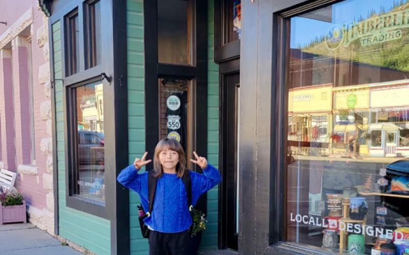 Anyela Carmack started her first day of school in 4th grade. Her mom, Gina Rosato, and dad, Wyatt Carmack’s shop Timberline Trading was the starting line for the day. Photo by Gina Rosato