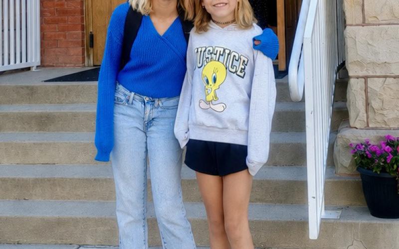 Ida Merrill and Maxine Brosh pose together in front of the school on Monday photo by Megan Brosh
