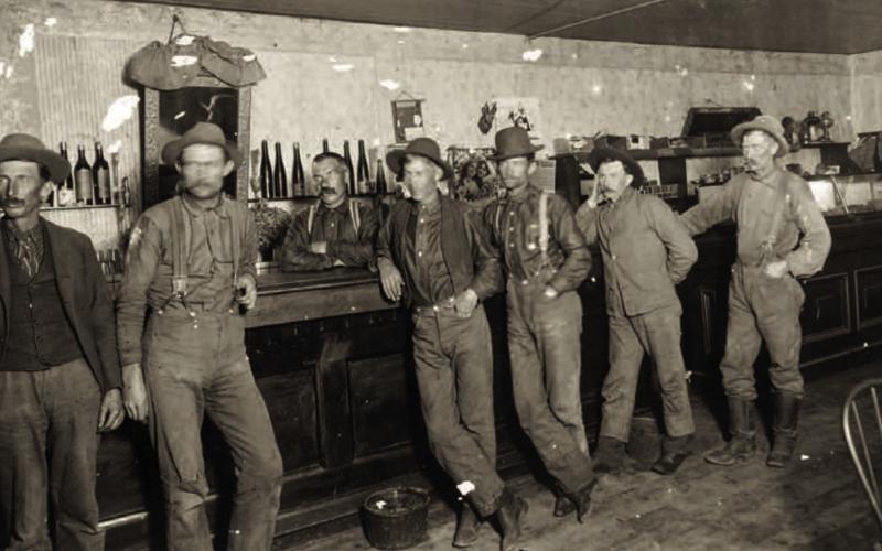 An unidentified saloon in the 1890s, with a long bar and relatively low ceiling, probably in the early 1890s. A poster on the wall mentions the Silverton Railroad. The saloon could have been in Silverton or Red Mountain Town. Photo courtesy of San Juan County Historical Society