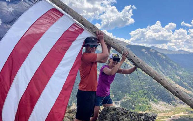 Brian and Gloria Kaasch-Buerger help put the American Flag back up on Anvil Mountain this past Sunday. Photo by Kaasch-Buerger