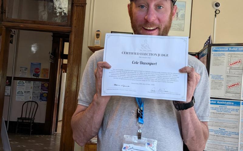Cole Davenport showing off his Election Judge Certification photo by Alex Lanis