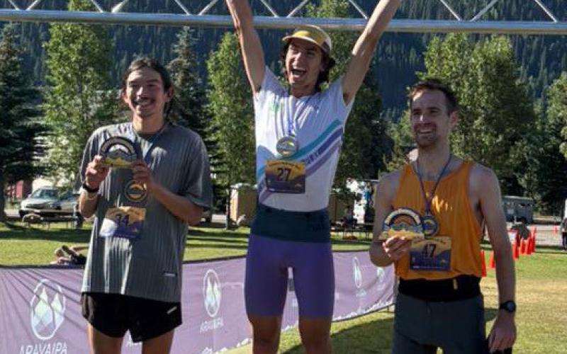 The top three male competitors on the podium. Photo credit Arvapai Running