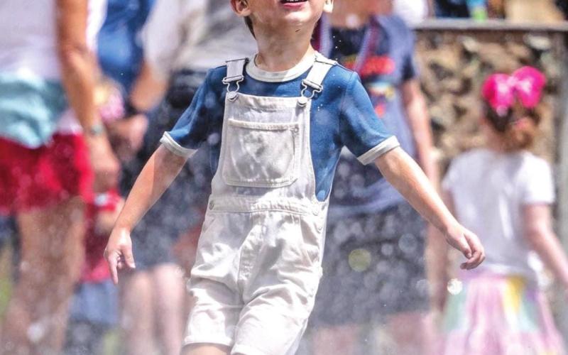 Parade goer enjoying the Silverton Fire Department’s water hoses during the parade Photo Credit Howie Stern