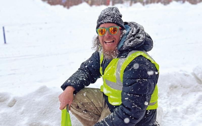 Volunteer Colin Trower looking happy in the snow while working the course. Photo credit DeAnne Gallegos